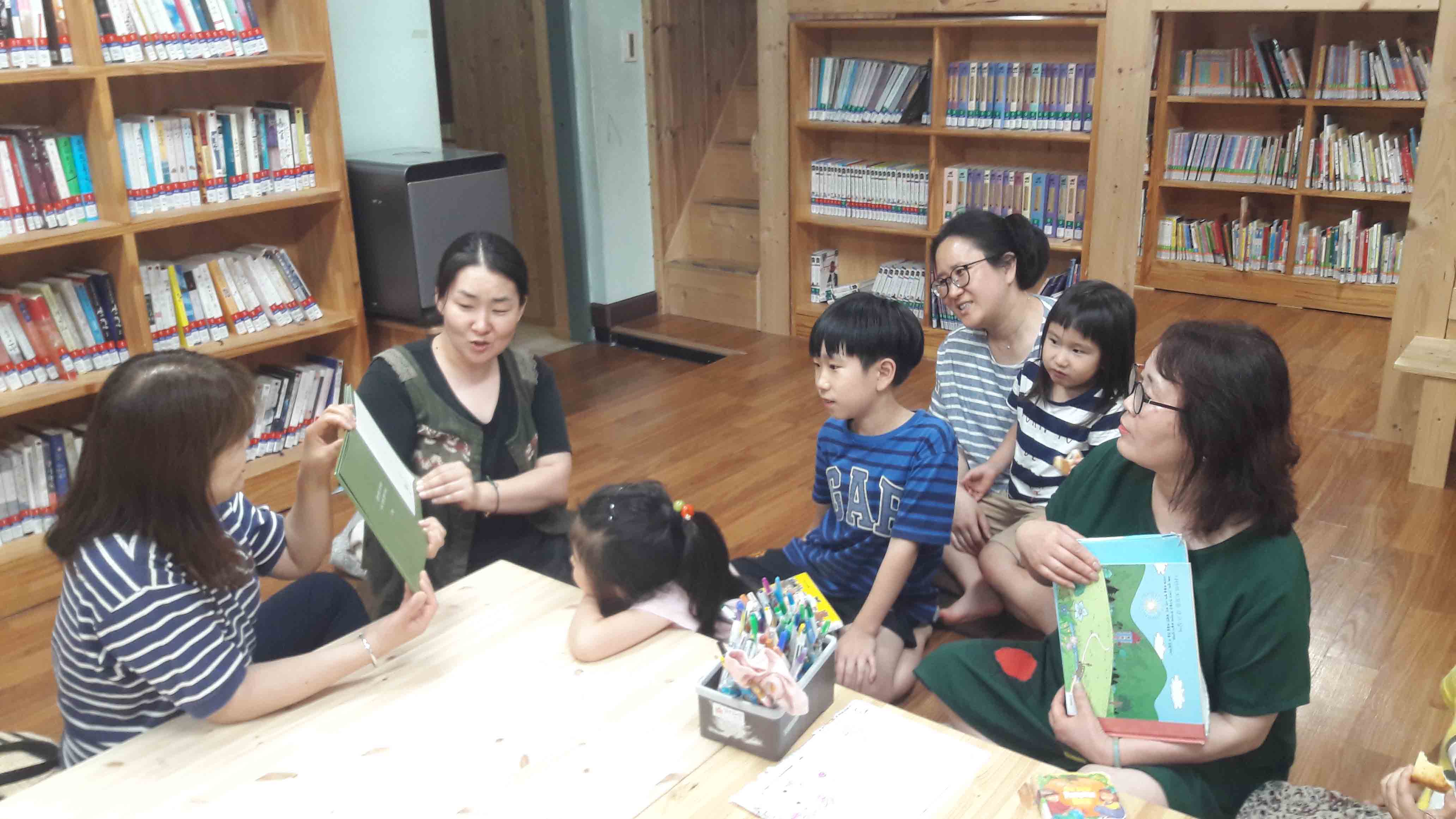 서로 어린이 문학책을 읽어주는 풍경 